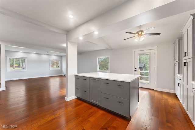 kitchen featuring dark hardwood / wood-style floors, gray cabinets, and ceiling fan