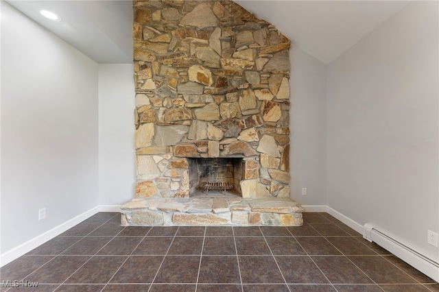 interior details featuring a fireplace and a baseboard heating unit