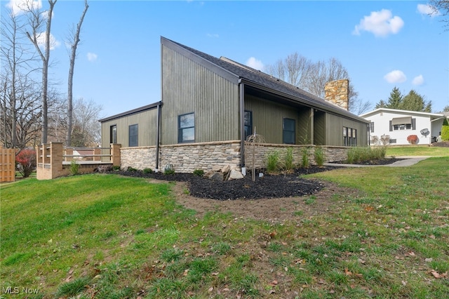 view of side of home with a lawn