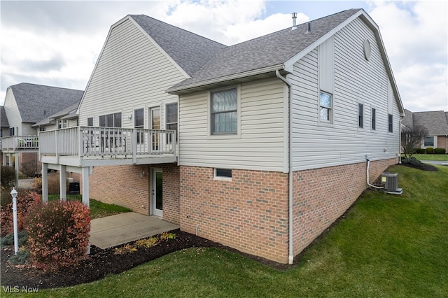 rear view of property with a lawn and a wooden deck