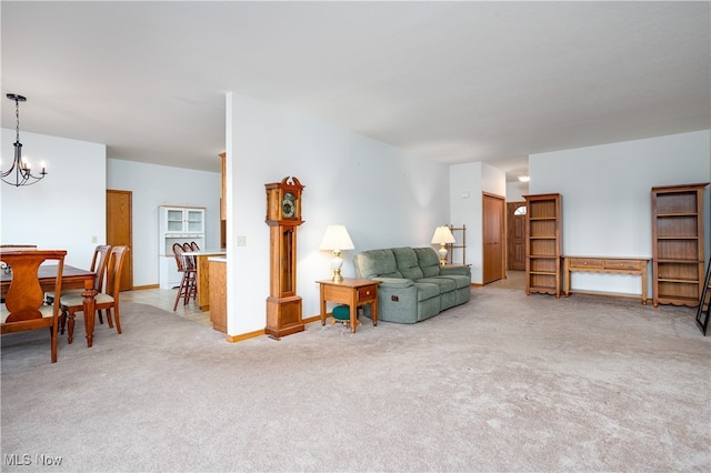 carpeted living room featuring a notable chandelier