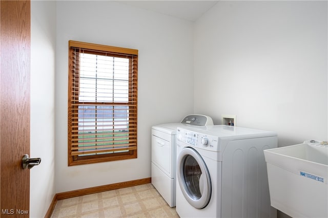 laundry area with washing machine and dryer and sink