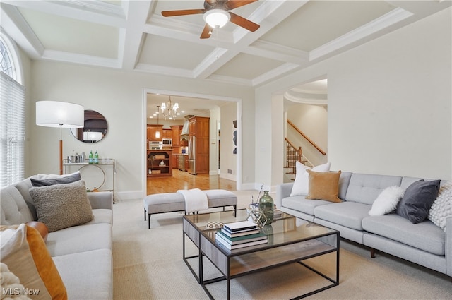 carpeted living room with ornamental molding, coffered ceiling, ceiling fan with notable chandelier, and beam ceiling