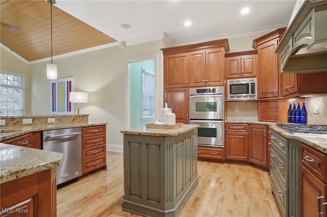 kitchen featuring a kitchen island, appliances with stainless steel finishes, decorative light fixtures, tasteful backsplash, and custom range hood