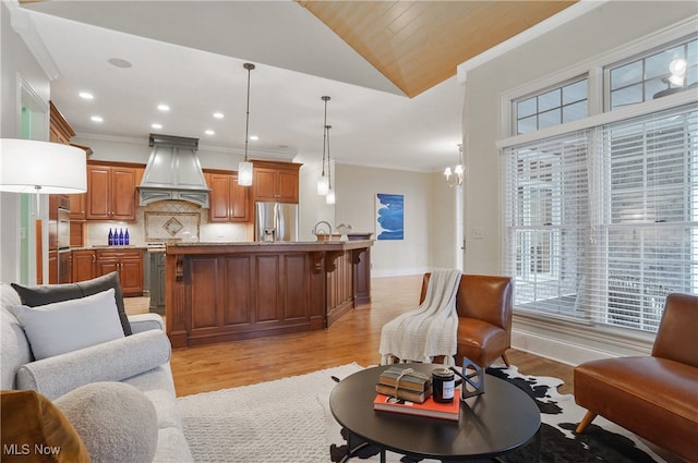 living room with vaulted ceiling, ornamental molding, wood ceiling, and light hardwood / wood-style flooring