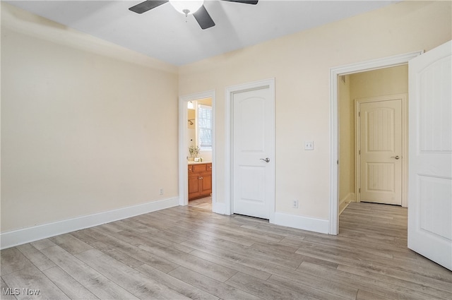 unfurnished bedroom with light hardwood / wood-style floors, ceiling fan, and ensuite bathroom