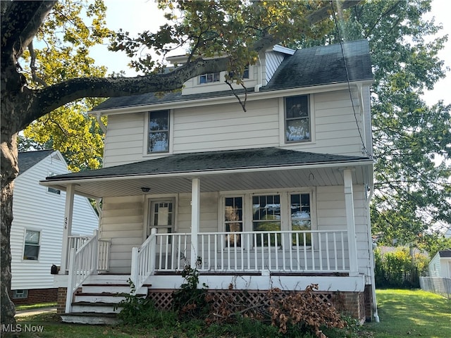 view of front facade with a front lawn and a porch