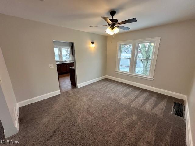 356 Babbitt Rd, Euclid, OH 44123 - unfurnished room featuring dark colored carpet, ceiling fan, and baseboards