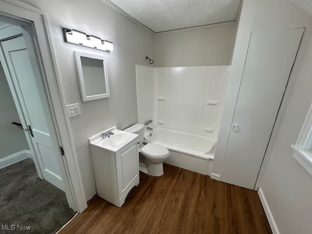 full bathroom featuring bathing tub / shower combination, a textured ceiling, toilet, vanity, and hardwood / wood-style flooring