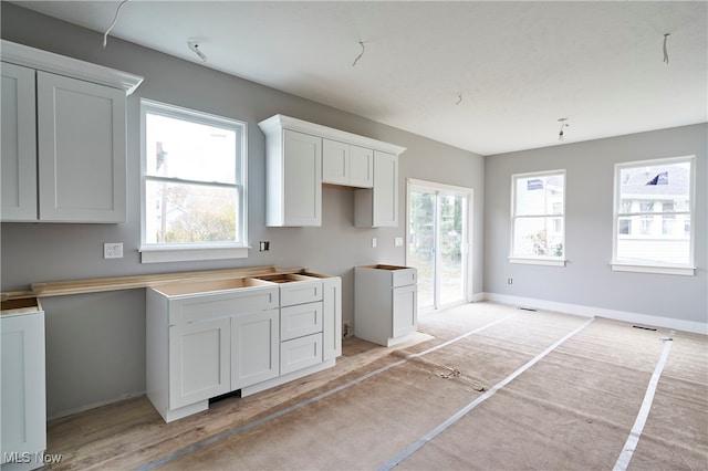 kitchen featuring white cabinetry and light wood-type flooring