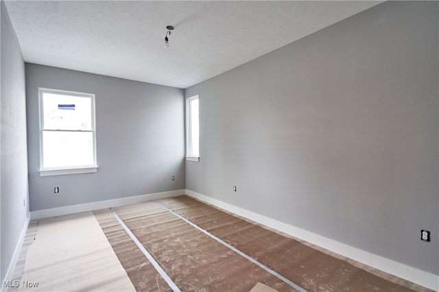 unfurnished room featuring a textured ceiling