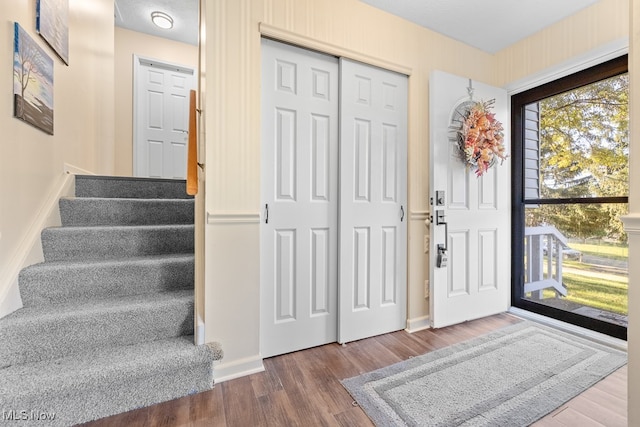 entrance foyer featuring wood-type flooring and a textured ceiling