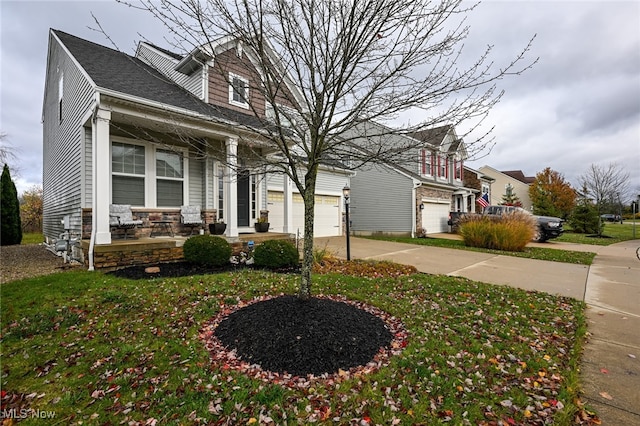 view of front facade featuring a garage, covered porch, and a front yard