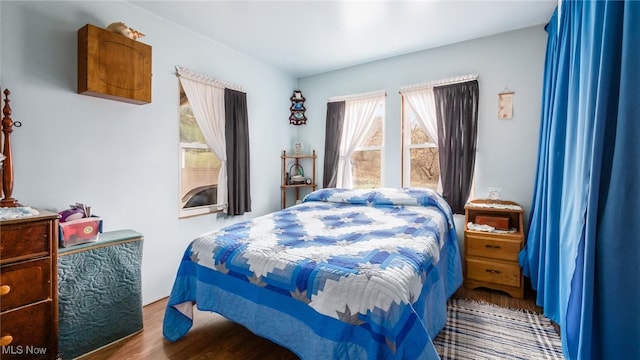 bedroom with hardwood / wood-style flooring