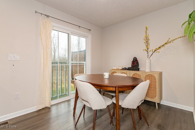 dining space with dark hardwood / wood-style flooring