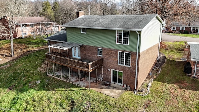 rear view of house with a patio, a deck, and a lawn