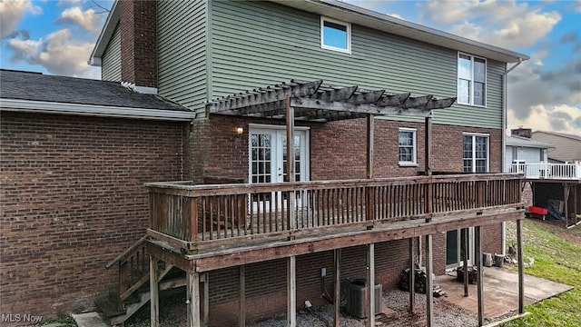 rear view of house with central AC, a pergola, a deck, and a patio