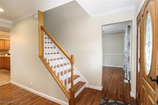 entrance foyer with dark hardwood / wood-style flooring and ornamental molding