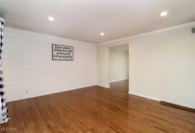 basement with dark hardwood / wood-style floors and ornamental molding