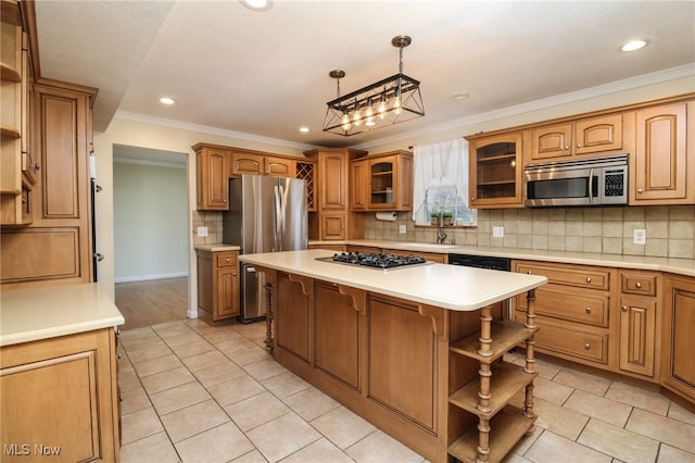 kitchen featuring ornamental molding, appliances with stainless steel finishes, tasteful backsplash, decorative light fixtures, and a kitchen island