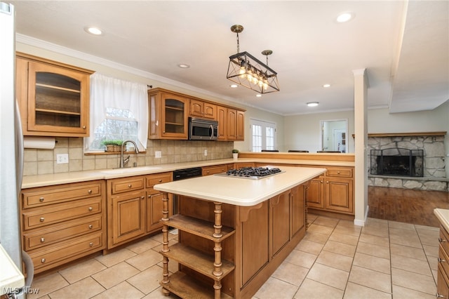 kitchen featuring sink, ornamental molding, stainless steel appliances, and a wealth of natural light