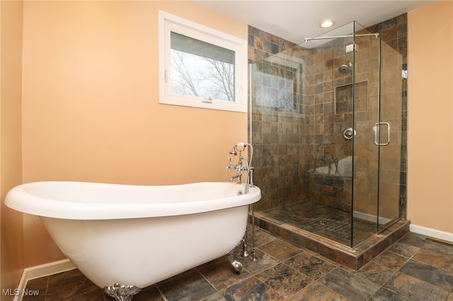 bathroom with shower with separate bathtub