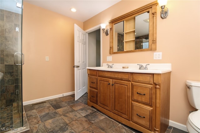 bathroom with vanity, toilet, and walk in shower