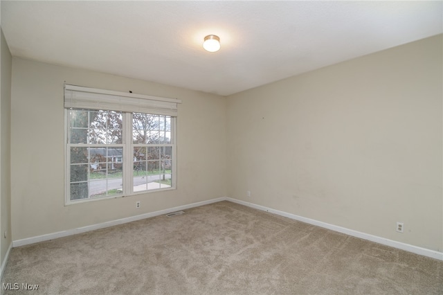 empty room featuring light carpet