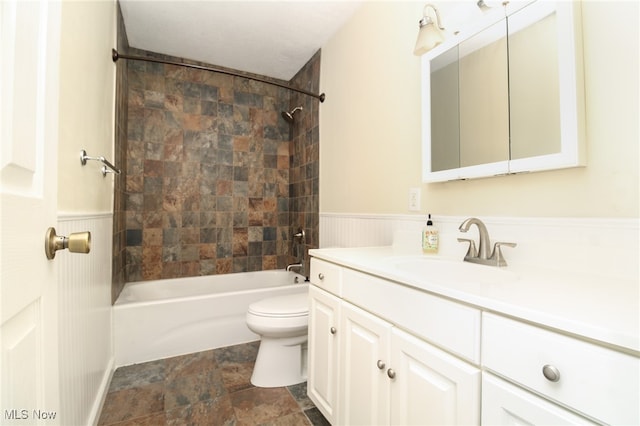 full bathroom with vanity, toilet, and tiled shower / bath