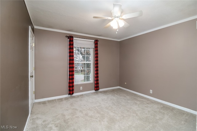 unfurnished room featuring crown molding, ceiling fan, and light colored carpet