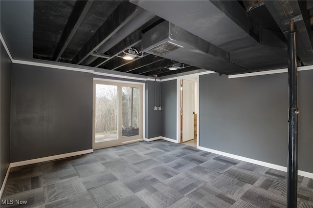 basement with carpet and ornamental molding