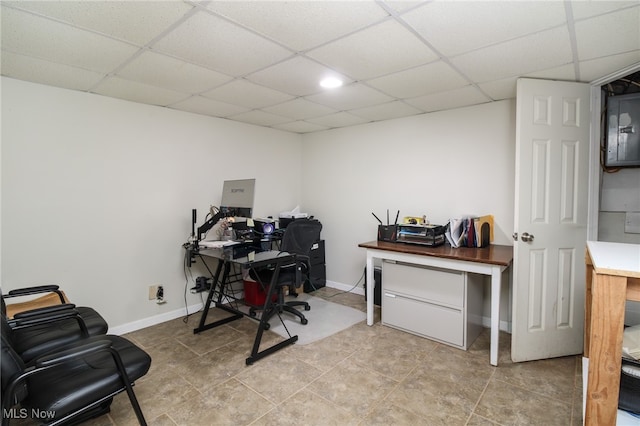 tiled home office featuring a paneled ceiling