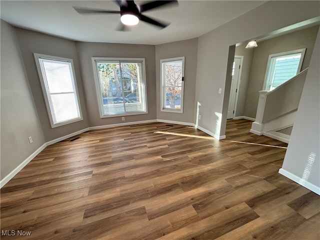 spare room with dark hardwood / wood-style floors and ceiling fan