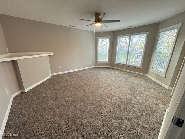 carpeted empty room featuring ceiling fan