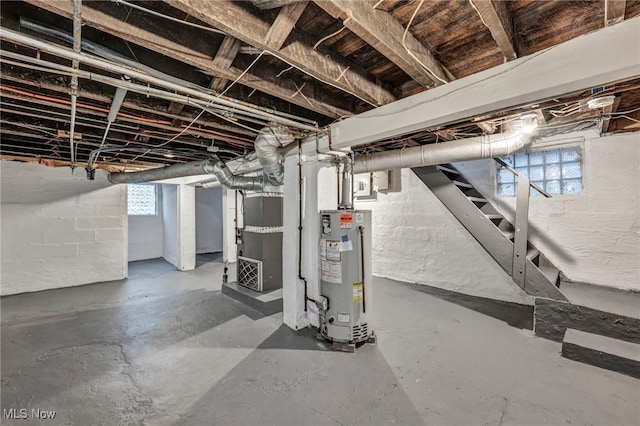 basement featuring heating unit and water heater