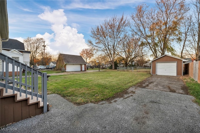 view of yard featuring an outdoor structure and a garage