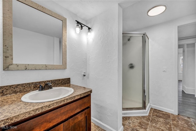 bathroom with tile patterned floors, vanity, and a shower with shower door