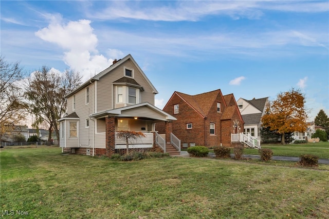 view of front facade with a front lawn and covered porch