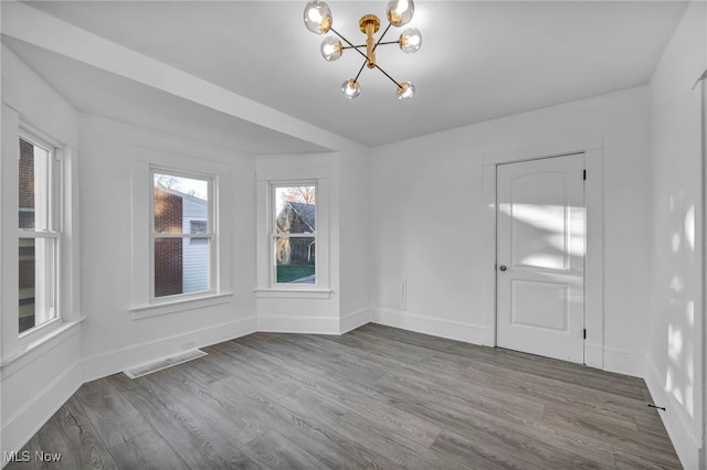 interior space with a chandelier and hardwood / wood-style flooring