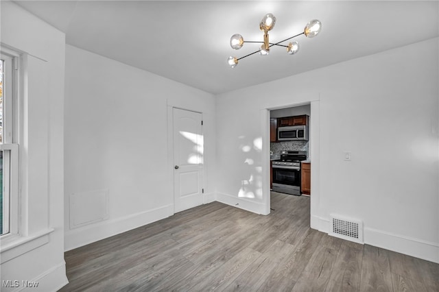 interior space with light hardwood / wood-style flooring and a chandelier