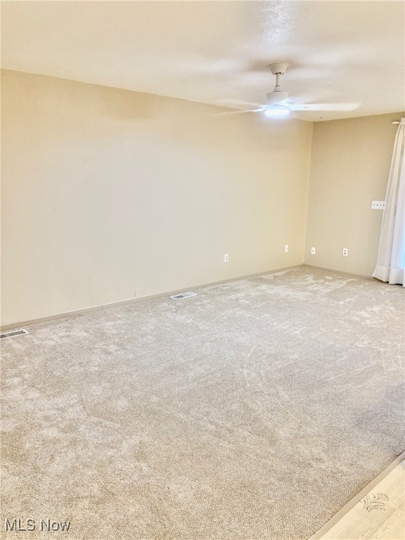 empty room with carpet and ceiling fan