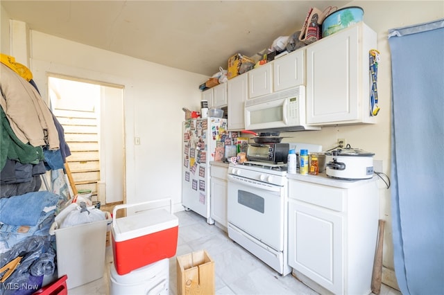 kitchen featuring white cabinets and white appliances