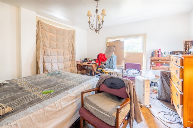 bedroom featuring light hardwood / wood-style floors and a notable chandelier