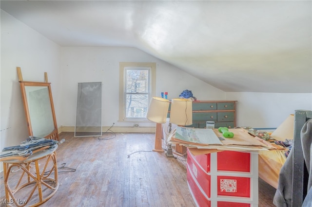 bedroom featuring hardwood / wood-style floors and lofted ceiling