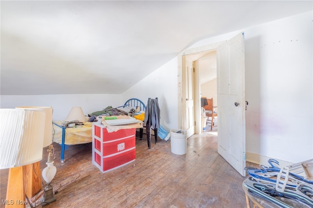 bonus room with lofted ceiling and hardwood / wood-style flooring