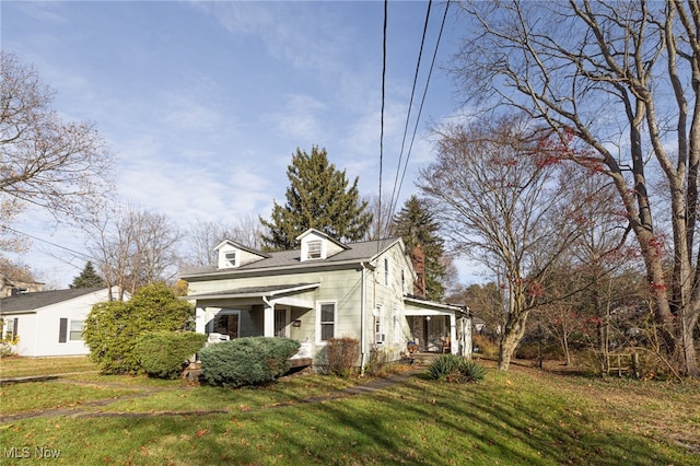 view of property exterior featuring covered porch and a lawn