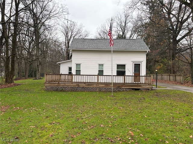 back of house with a yard and a deck