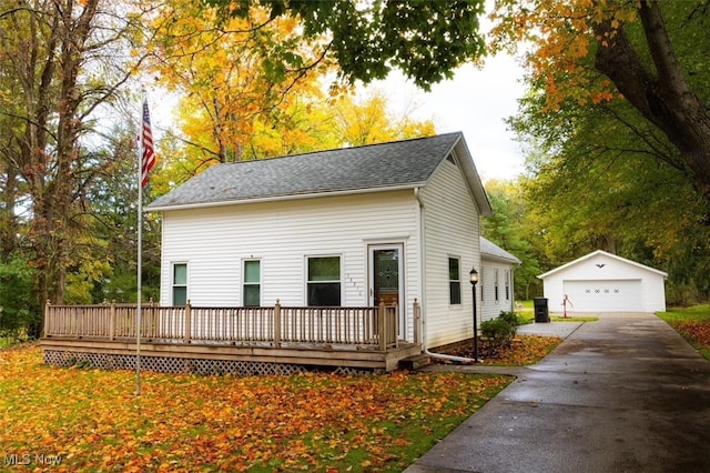 view of front of house featuring a garage, an outdoor structure, and a deck