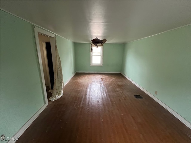 empty room featuring dark wood-type flooring