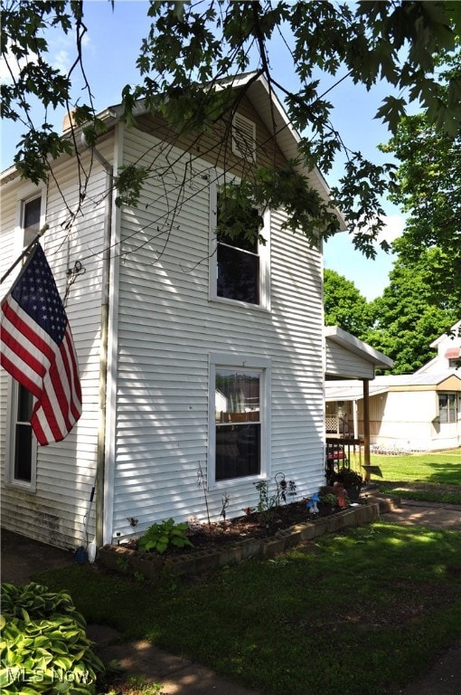 view of side of home featuring a yard